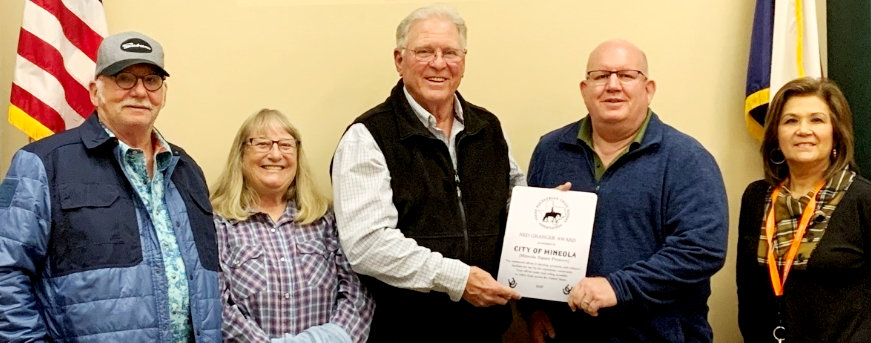 Jim and Jeanne Hinderman, left, of Lindale and Steve Hanock of TETRA presents the Ned Granger Award to Mineola Mayor Kevin White and City Manager Mercy Rushing.